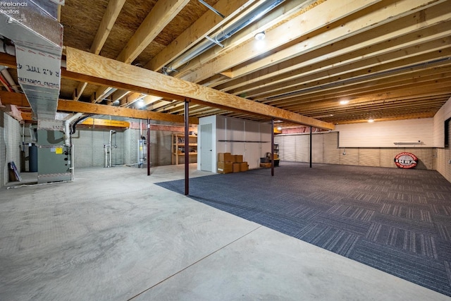 unfinished basement with heating unit and brick wall