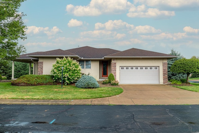 view of front of house with a garage and a front lawn