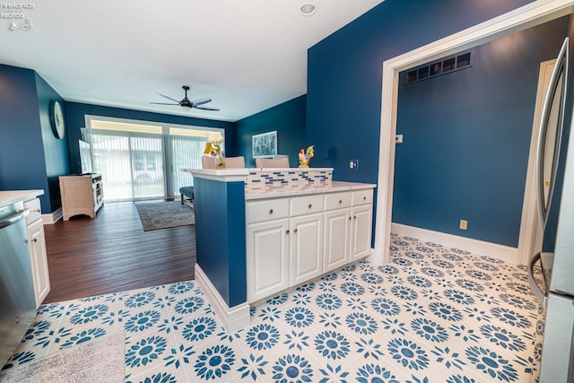 kitchen featuring ceiling fan, stainless steel appliances, white cabinetry, and light hardwood / wood-style floors