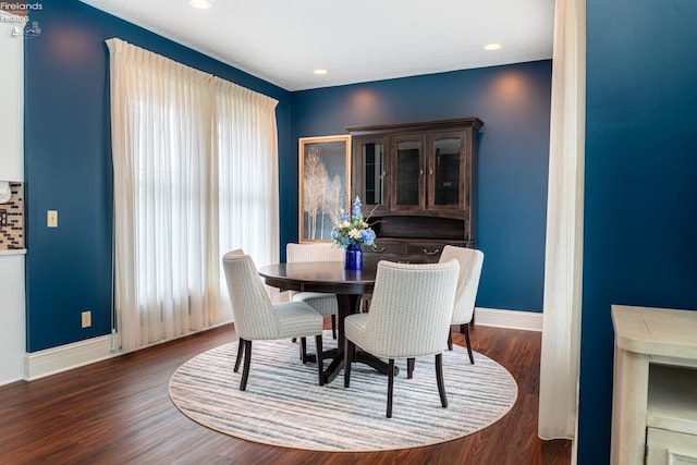 dining room with a wealth of natural light and dark hardwood / wood-style flooring