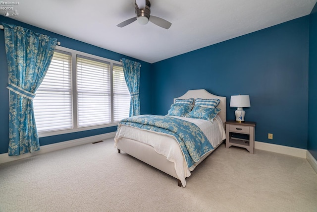 bedroom featuring ceiling fan and carpet