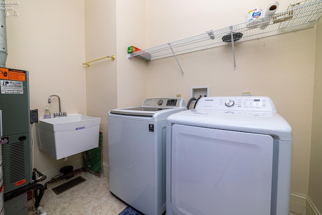 washroom with washer and clothes dryer and sink