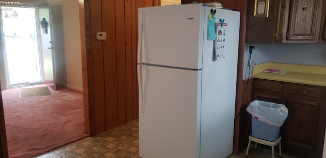 kitchen with a healthy amount of sunlight, white fridge, and carpet floors