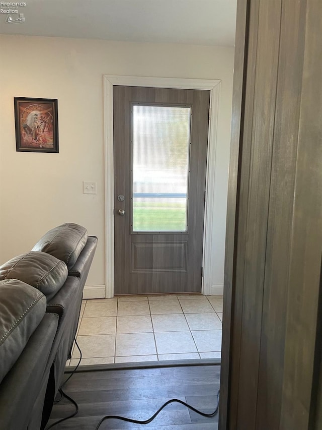 doorway with light tile patterned floors