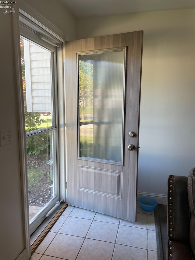 doorway to outside featuring light tile patterned floors