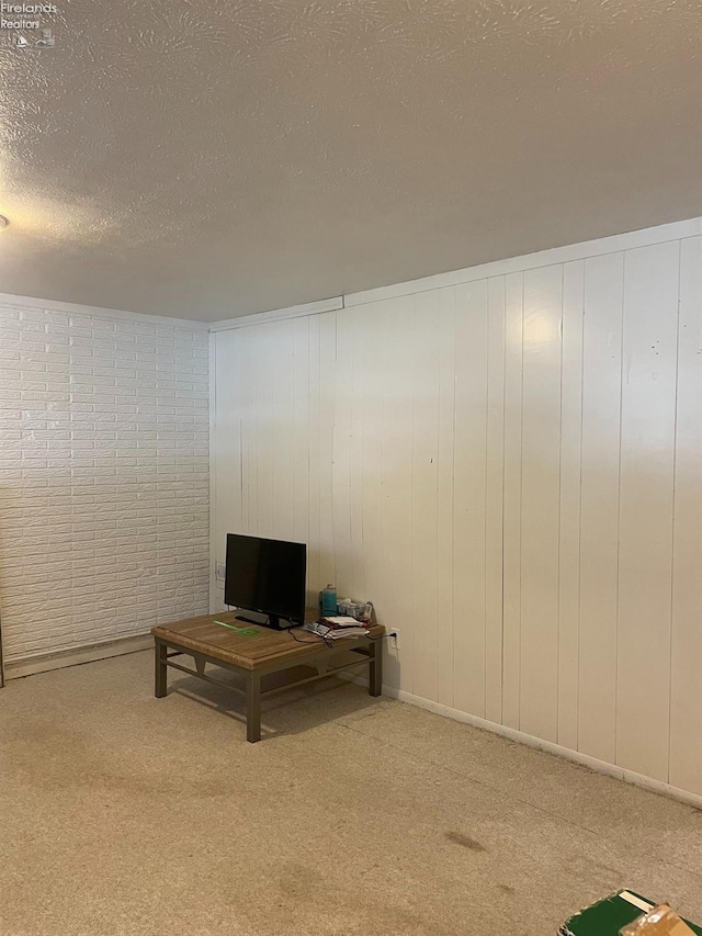 unfurnished living room featuring carpet and a textured ceiling