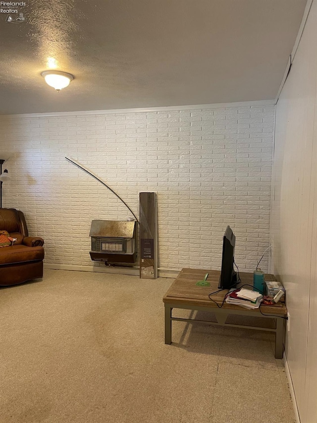 living room with brick wall, crown molding, carpet floors, and a textured ceiling