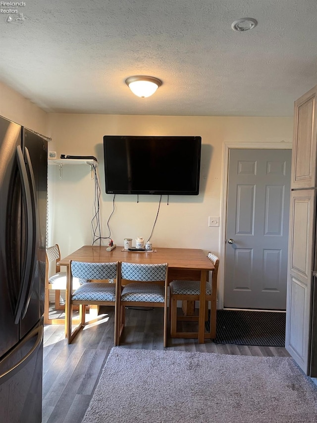 office area with dark hardwood / wood-style flooring and a textured ceiling