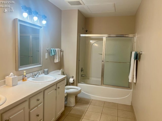 full bathroom with vanity, toilet, tile patterned floors, and enclosed tub / shower combo