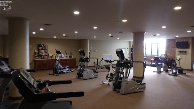 exercise room featuring decorative columns