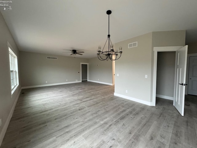 10 Eagle View Dr, Monroeville, OH 44847 - unfurnished dining area with a chandelier, a ceiling fan, baseboards, and wood finished floors