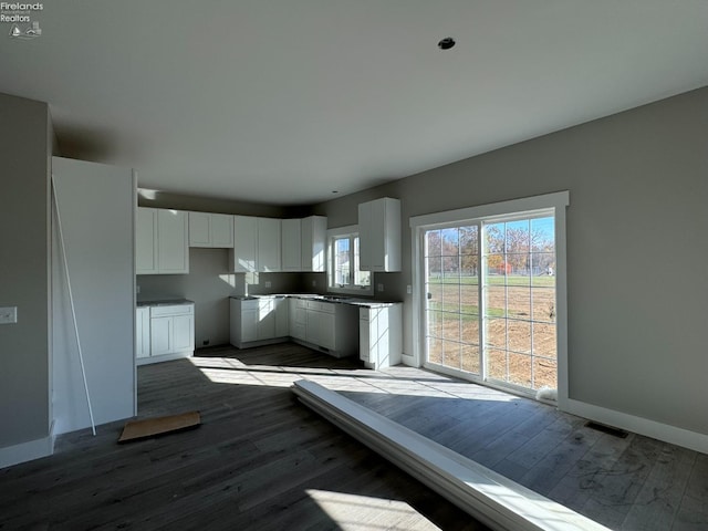 kitchen featuring hardwood / wood-style floors and white cabinets