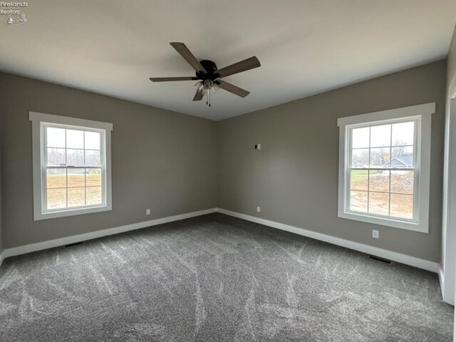 10 Eagle View Dr, Monroeville, OH 44847 - unfurnished room featuring baseboards, dark carpet, and a ceiling fan