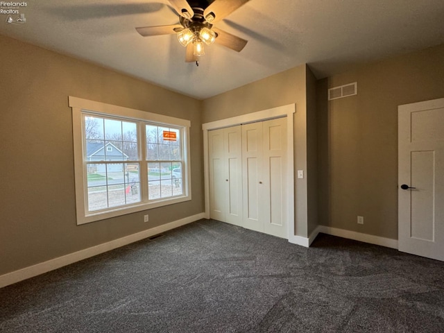 10 Eagle View Dr, Monroeville, OH 44847 - unfurnished bedroom featuring dark carpet, baseboards, a closet, and ceiling fan