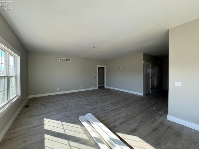 unfurnished room with dark hardwood / wood-style floors