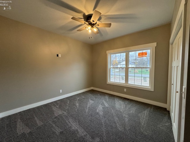 10 Eagle View Dr, Monroeville, OH 44847 - empty room with dark carpet, a ceiling fan, and baseboards