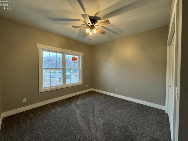 10 Eagle View Dr, Monroeville, OH 44847 - unfurnished room featuring a ceiling fan, dark carpet, and baseboards