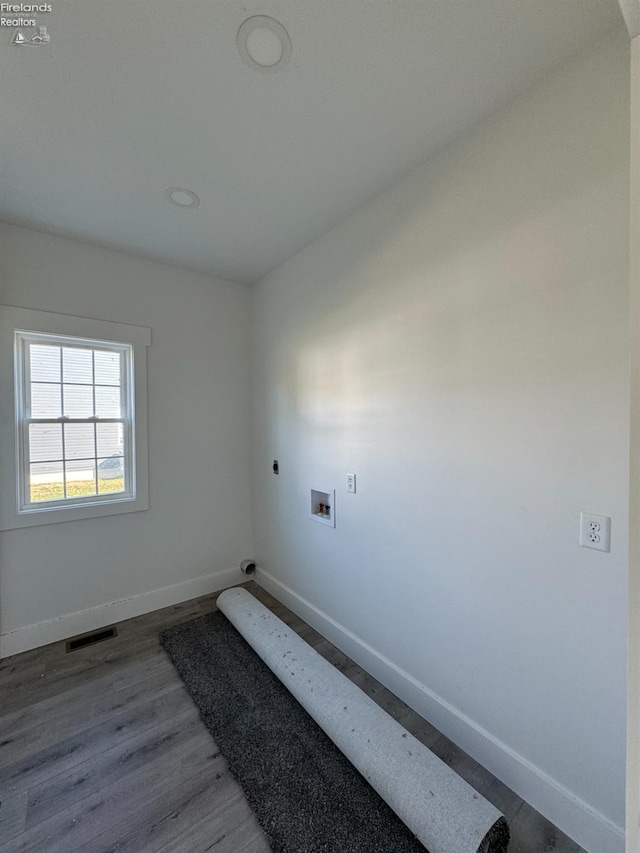 spare room featuring wood-type flooring