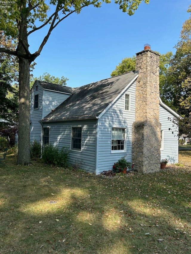 view of property exterior with a chimney and a yard