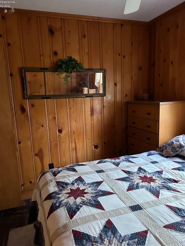 bedroom featuring wood walls