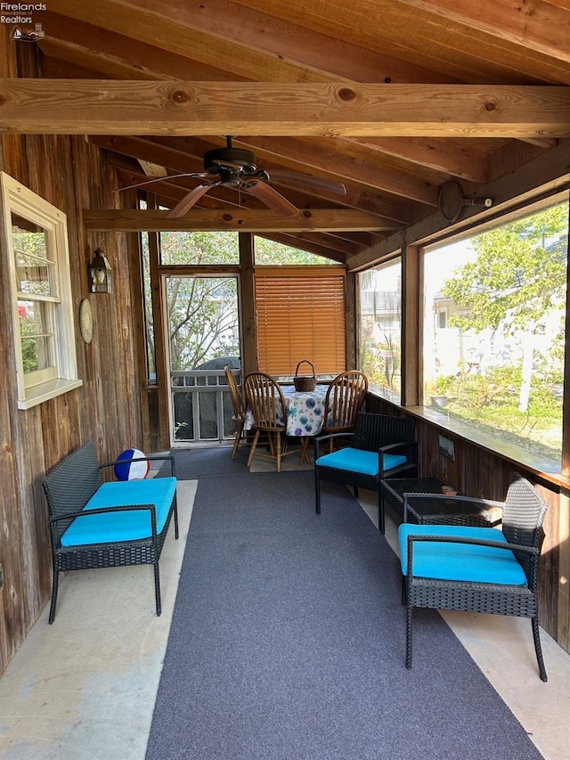 sunroom / solarium featuring ceiling fan and vaulted ceiling