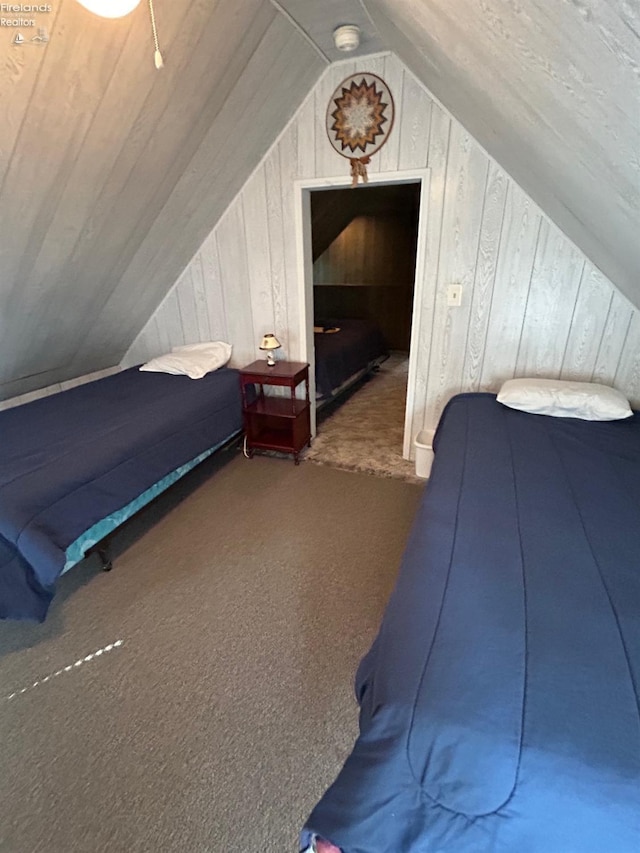 carpeted bedroom with wood walls and lofted ceiling