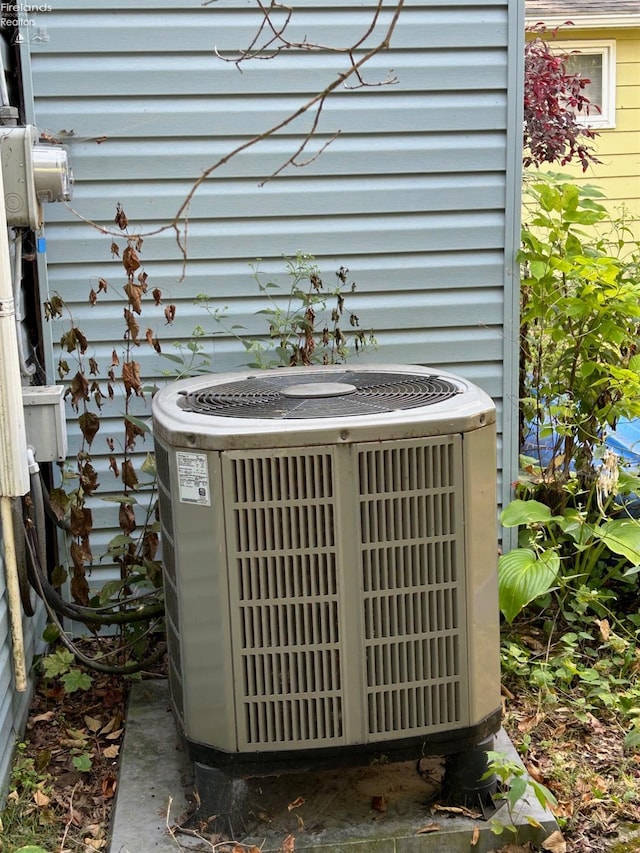 exterior details featuring electric meter and cooling unit