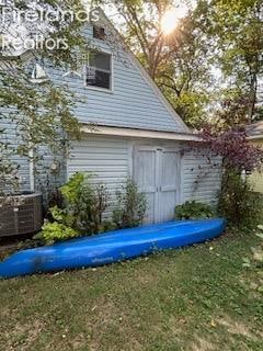 view of outbuilding with a lawn