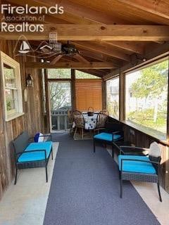 sunroom / solarium featuring lofted ceiling