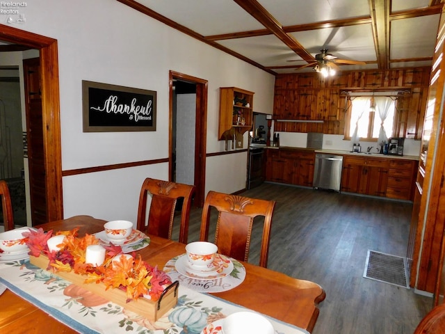 dining area featuring coffered ceiling, dark hardwood / wood-style floors, wood walls, ceiling fan, and ornamental molding