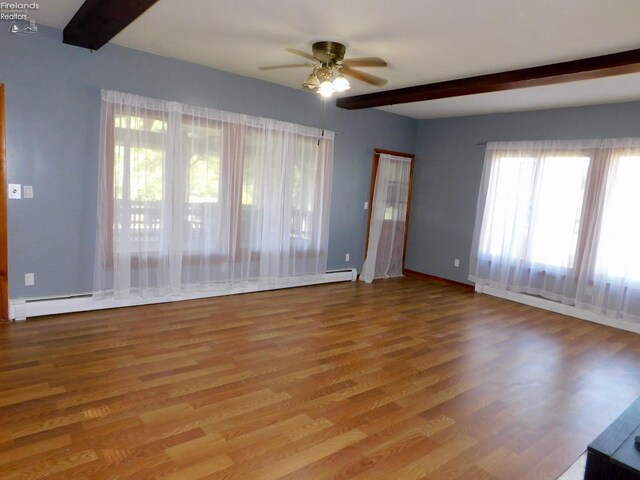 unfurnished room with a wealth of natural light, ceiling fan, and hardwood / wood-style floors