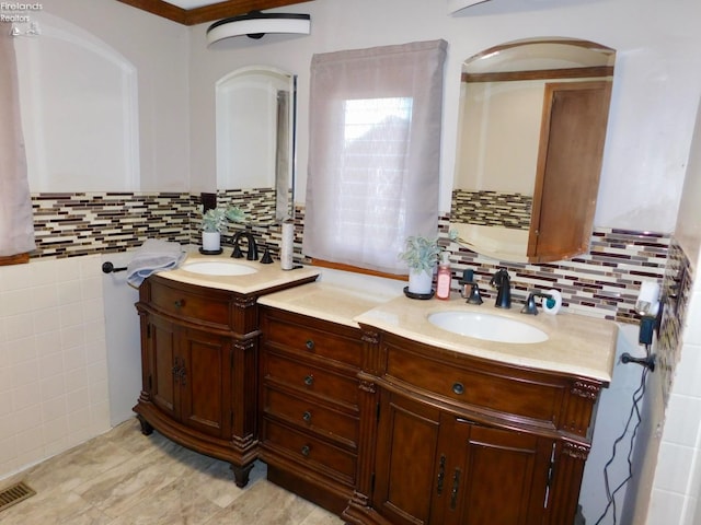 bathroom featuring tile walls, tasteful backsplash, and vanity