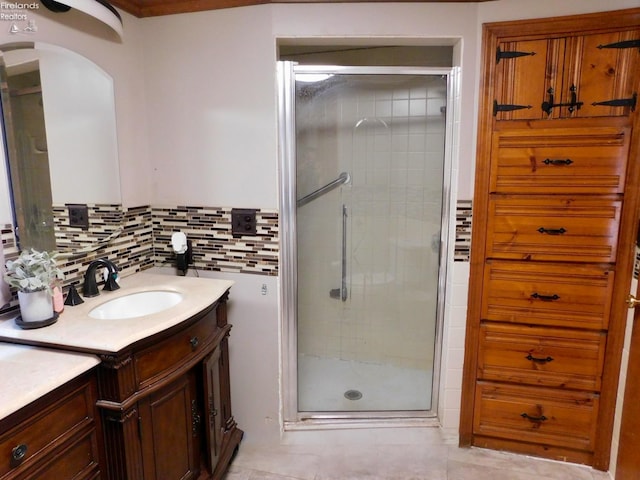 bathroom featuring tile patterned flooring, walk in shower, decorative backsplash, and vanity