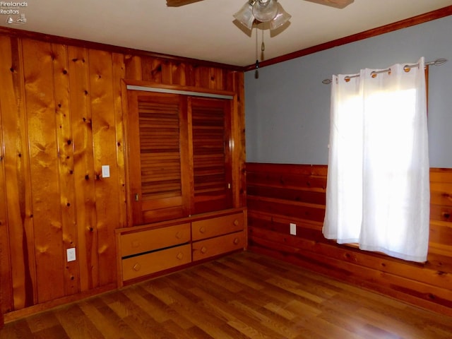 interior space featuring ceiling fan, ornamental molding, hardwood / wood-style floors, and multiple windows