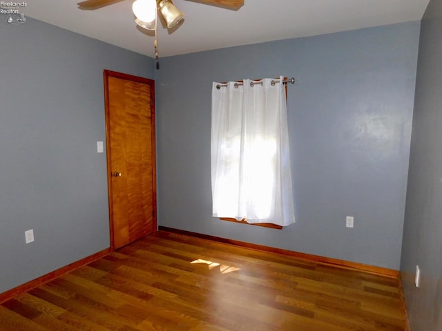 spare room featuring hardwood / wood-style floors and ceiling fan