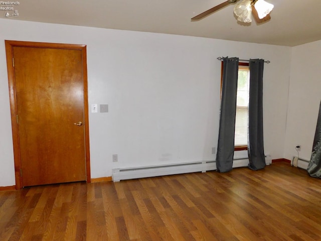 unfurnished room featuring baseboard heating, hardwood / wood-style flooring, and ceiling fan