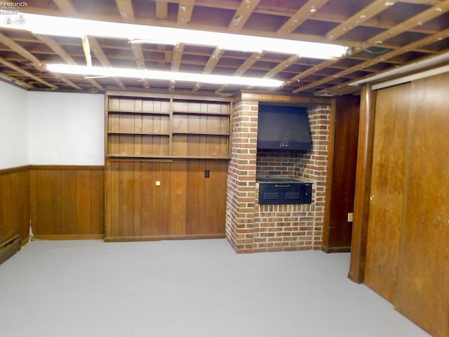 basement with wooden walls and a fireplace