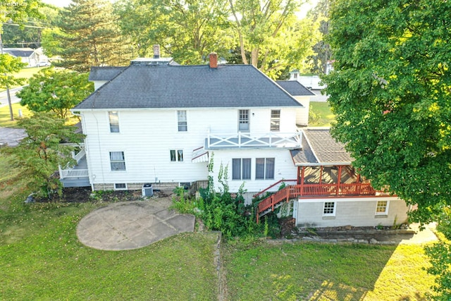 back of house featuring a yard and a patio area