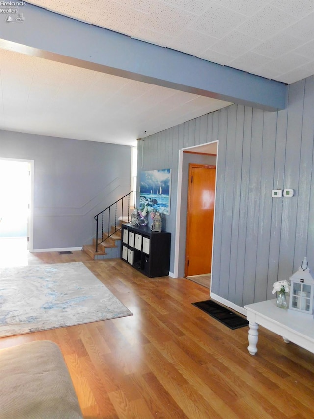 interior space with hardwood / wood-style floors and beamed ceiling