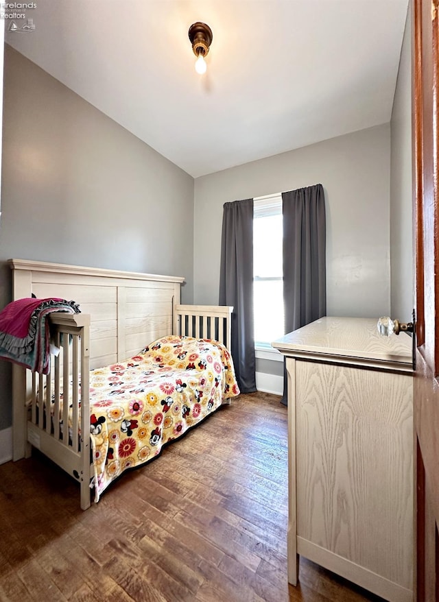 bedroom with dark hardwood / wood-style floors