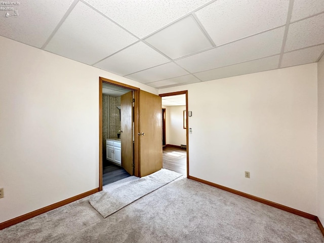 unfurnished bedroom with carpet and a drop ceiling