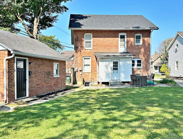 rear view of house with a lawn