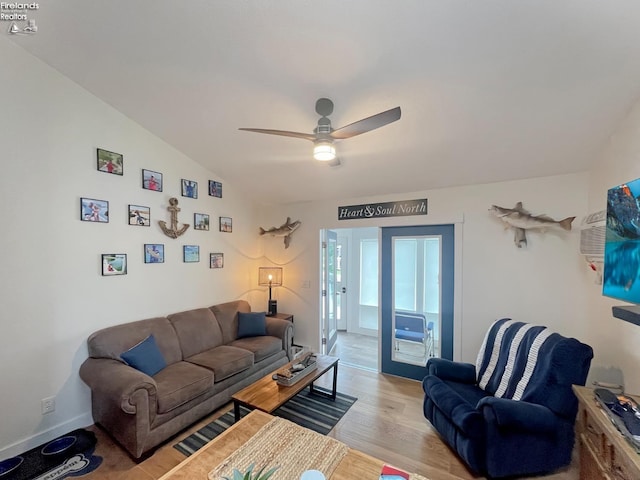 living room with vaulted ceiling, light hardwood / wood-style flooring, and ceiling fan