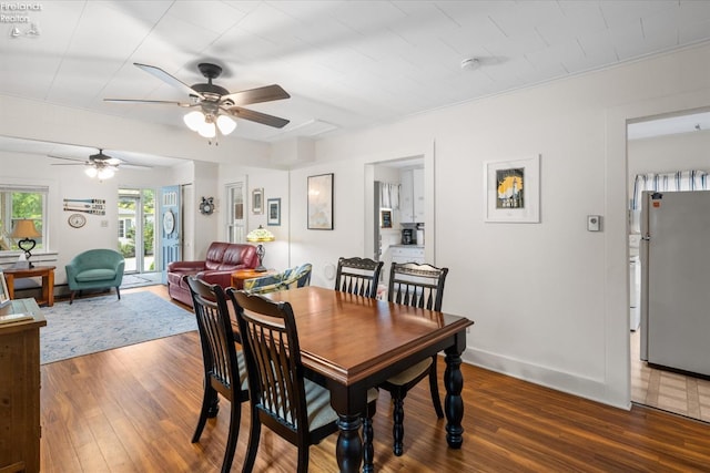 dining room with dark wood-type flooring and ceiling fan