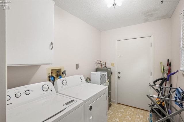 laundry area featuring a textured ceiling and separate washer and dryer