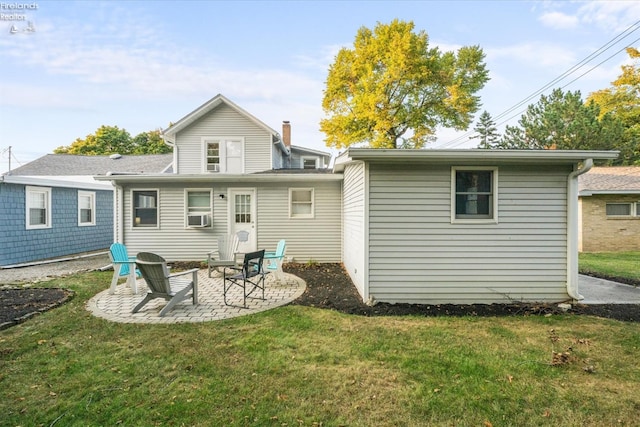 rear view of property with a patio area, a lawn, and cooling unit