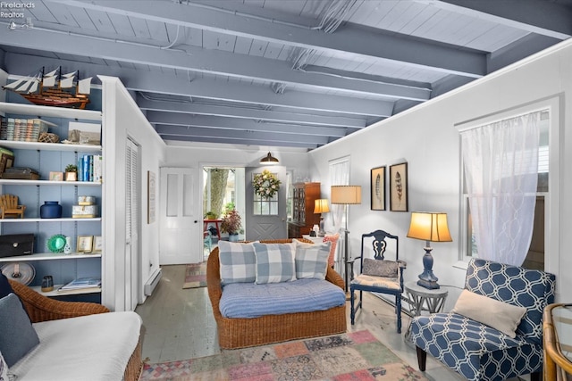 living room with a baseboard heating unit and beam ceiling