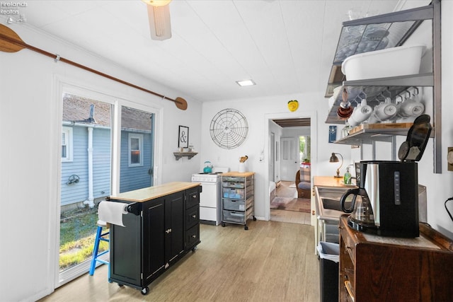 interior space featuring ceiling fan, white range, and light hardwood / wood-style floors