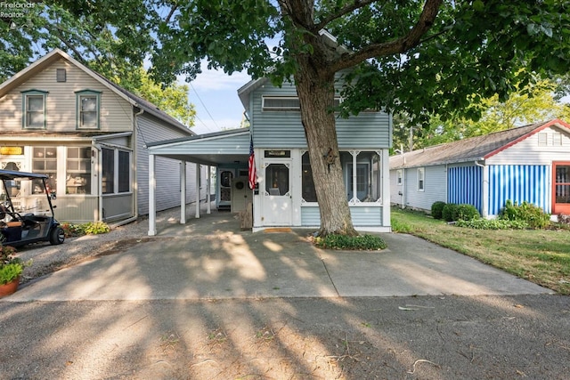 view of front of house with a carport and a sunroom