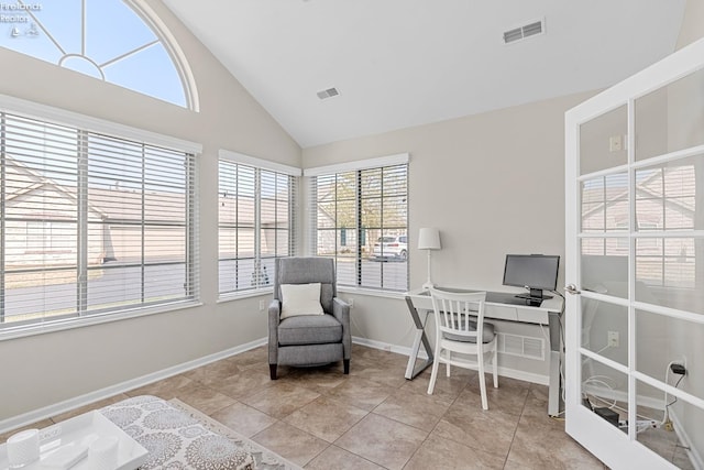 tiled office space featuring high vaulted ceiling